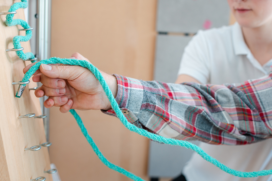 Man training his dexterity at the rope board for occupational therapy NDIS